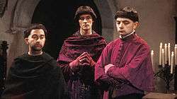 "Prince Edmund, Baldrick and Lord Percy in purplse clerical cassocks"