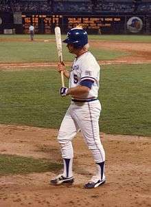 Wearing a blue helmet and white jersey of the Atlanta Braves, Bob Horner clutches his bat with both hands