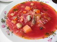 A bowl of borscht with beans and other vegetables