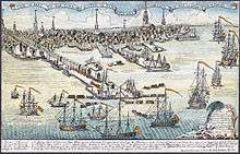 A wide view of a port town with several wharves. In the foreground there are eight large sailing ships and an assortment of smaller vessels. Soldiers are disembarking from small boats onto a long wharf. The skyline of the town, with nine tall spires and many smaller buildings, is in the distance. A key at the bottom of the drawing indicates some prominent landmarks and the names of the warships.