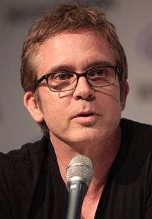 A headshot of a Caucasian man wearing glasses.