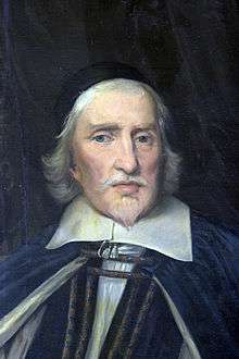 A painting of the head and shoulders of a robed white man with mid-length white hair and a Van Dyck.