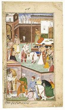 In the top, central figure of a young Chirakari touching the feet of a middle-aged Gautma, both dressed in royal Mughal clothes. Numerous royal ladies surround them. In the bottom of the painting, outside the door are royal men with horses.