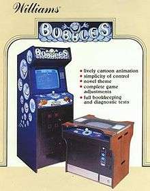 A tan, vertical rectangular poster. The poster depicts two arcade cabinets side-by-side. The left cabinet is blue and taller than the right one, which is brown. Above the cabinets read the text "Williams" and "Bubbles".
