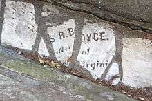Fragments of a headstone reading S R.BOYCE.