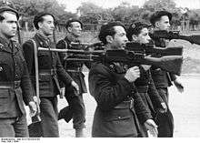Black-and-white photo of men in uniform with guns
