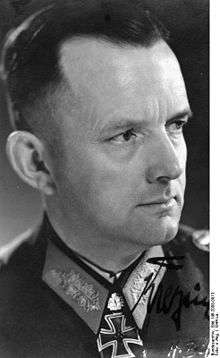 A black-and-white photograph of a man in semi profile wearing a military uniform and a neck order in shape of an Iron Cross.