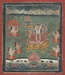 Depicted enthroned, a decapitated, dark-complexioned woman wearing a red/orange sari holds a sword in her left hand and her own severed head  (with a lotus crown) on a platter in her right hand. Five seated devotees (including one with a ram's head) with folded hands surround her. A lake with a large lotus is in the foreground.