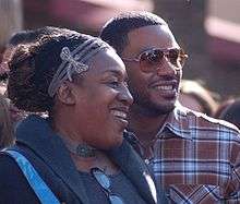 Head and shoulders photo of African-American actors C.C.H. Pounder and Laz Alonso standing together in street clothes
