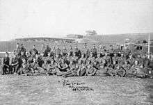 A group of soldiers standing, kneeling or lying down in a group photograph