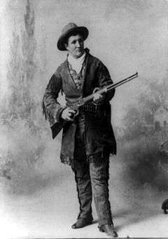 Woman in western style clothes holding a rifle