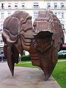 a tall open patinated bronze sculpture