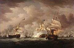 On a dark stormy sea beneath towering clouds, an indeterminate number of sailing warships battle. In the foreground are three ships, one to the right of the frame and one in the centre bridged by clouds of smoke as the mainmast of the far right ship, which bears a prominent horizontally striped flag is toppling. To the left of the frame and partially obscuring the central ship is a third vessel that drifts as flames leap from its deck.