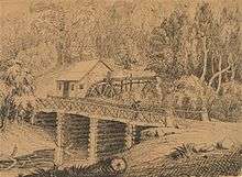 drawing of a wooden building with a water wheel behind a log bridge