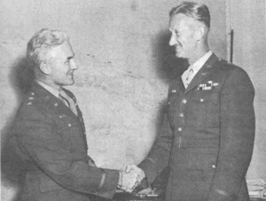 Two men in Army uniforms shake hands
