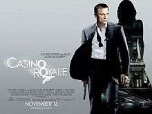 The poster shows Daniel Craig as James Bond, wearing a business suit with a loose tie and holding a gun. Behind him is a silhouette of a woman showing a building with a sign reading "Casino Royale" and a dark grey Aston Martin DBS below the building. At the bottom left of the image is the title "Casino Royale" – both "O"s stand above each other, and below them is a 7 with a trigger and gun barrel, forming Bond's codename: "Agent 007" – and the credits.