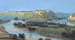 A panoramic painting showing a river with a small island at in the middle. There some small buildings on the riverbanks and in the distance, on a hilltop overlooking the river, is a picturesque fortress with white walls and a flag flying over it.