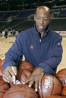A basketball player is signing a basketball