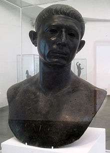 A bronze bust of the head and shoulders of a middle-aged man, with the word "CATO" inscribed across the chest