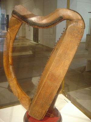  A Photo of a wooden harp with two curved sides.