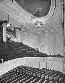 Interior of 1100-seat auditorium, showing main floor, balcony, and ceiling decoration and lamps