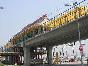 An elevated train station with a red and yellow pagoda-style roof.
