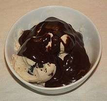 Ice cream balls covered in chocolate syrup.