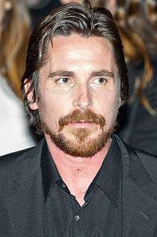 Headshot of Christian Bale looking to the right of the camera