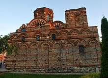 A Byzantine-style church decorated with blind arcades and missing entrances on this side