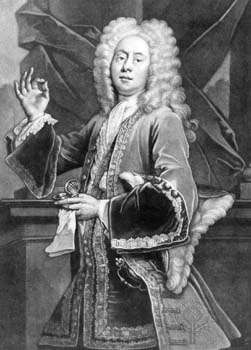 Black and white image of a man facing center. He is wearing a shoulder length whig, has an elaborate coat with a cloth around his neck. He has a hat under his left arm and both a glove and a watch in his left hand. He is holding up his right hand with the thumb and pointer pressed together.