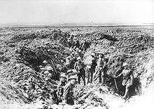 Soldiers in a ruined trench system the landscape is devoid of any flora or fauna