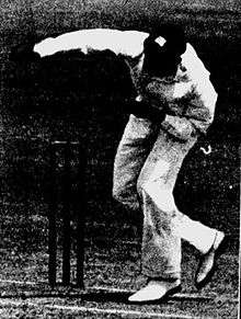 A cricketer bowling.