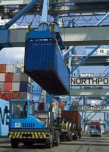 A container being loaded on a prime mover in Northport. Container being loaded on one of the Prime Mover.