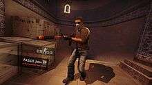 An in-game screenshot in which a member of the Terrorist team is poised while holding an assault rifle with a custom skin. A caption in the bottom-left reads "FASICO John killed you with their knife".