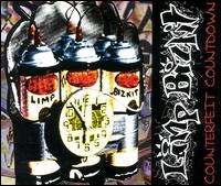 A photograph of a homemade bomb with a clock attached to it. In the right corner, the words "Limp Bizkit" appear.