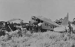 Monoplane lying in pieces in scrub