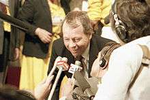 Colour photograph of former federal Indian affairs minister David Crombie speaking to reporters on the floor of the 1983 Progressive Conservative leadership convention