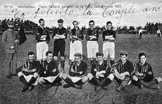 Old team photo, with half the players sitting and half standing