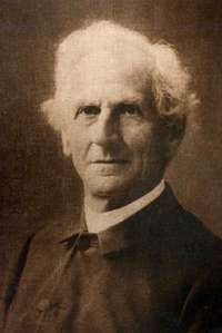 monochrome photograph of an elderly man wearing austere clerical clothing