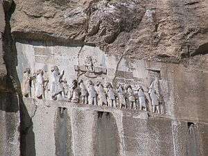 Frieze in a rock with many people.