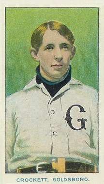 A baseball card of a man wearing a high-collared white baseball jersey with a black "G" on the left breast.