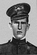 A head and shoulders portrait of a young, cleanshaven man in a formal military uniform, wearing a hat.