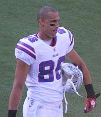David Nelson, a 25-year-old man, walking in the white uniform of the Buffalo Bills with his helmet under his arm.