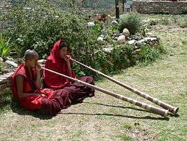 Monks playing dungchen, Dechen Phodrang monastic school, Thimphu
