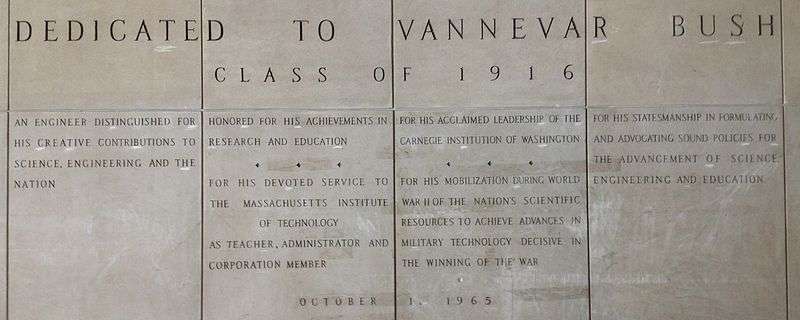 Four large panels with words carved in stone. The inscriptions reads: "Dedicated to Vannevar Bush Class of 1916. An engineer distinguished for his creative contributions to science, engineering and the nation. Honored for his achievements in research and education. For his devoted service to the Massachusetts Institute of Technology as teacher, administrator and corporation member. For his acclaimed leadership of the Carnegie Institute of Washington. For his mobilization during World War II of the nation's scientific resources to achieve advances in military technology decisive in the winning of the war. For his statesmanship in formulating and advocating sound policies for the advancement of science, engineering and education. October 1, 1965"