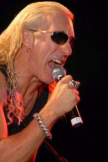 Snider singing into a microphone