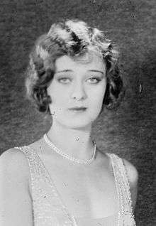 Portrait bust of a young Dolores Costello, facing the camera, looking stylish and slightly unhappy or bored