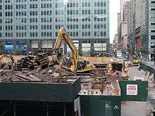 A machine moves demolition debris