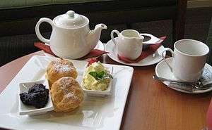 Tea (beverage) and scones on a table.