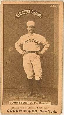A yellowed cigarette card. Pictured is a man in a white uniform with the words "Boston" curved on the uniform. The words "OLD JUDGE Cigarettes" are above the player.
